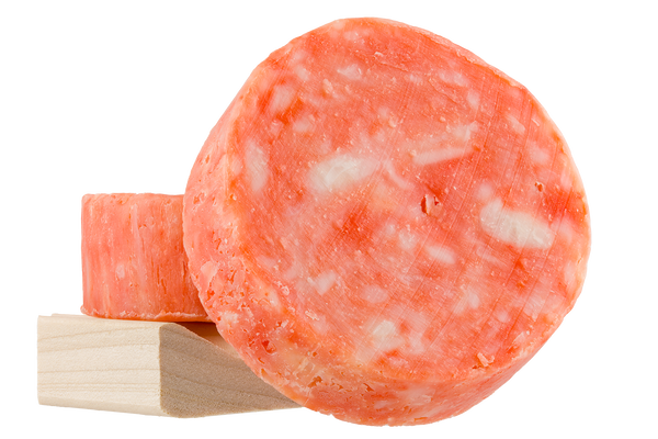 Photo of two handcrafted soap bars on a natural wooden soap dish to show top and  thickness. 